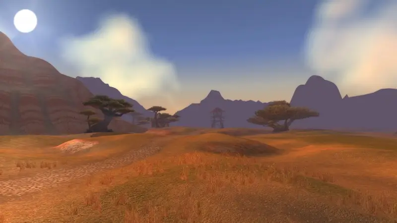 Das Brachland im klassischen Azeroth: goldene Savanne mit Schirmbäumen unter blauem Himmel